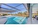 Relaxing screened pool overlooking manicured landscaping with a view of the beautiful pond at 3837 Torrey Pines Blvd, Sarasota, FL 34238
