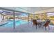 Screened in pool featuring plenty of space for outdoor dining and backyard pond views at 3837 Torrey Pines Blvd, Sarasota, FL 34238