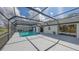 View of the screened pool and covered patio from the home's backyard at 3837 Torrey Pines Blvd, Sarasota, FL 34238