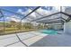 Backyard view of screened pool and outdoor living area with views of the pond at 3837 Torrey Pines Blvd, Sarasota, FL 34238