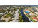 An aerial view showcasing a waterfront community with canal access to open water and nearby golf course at 4721 Mount Vernon Dr, Bradenton, FL 34210