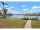 Tranquil gazebo overlooking a lake, complete with rocking chairs and a paved pathway at 4721 Mount Vernon Dr, Bradenton, FL 34210