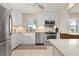 Well-lit kitchen with white cabinets, stainless steel appliances, and tan marble countertops at 4721 Mount Vernon Dr, Bradenton, FL 34210