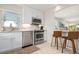 Renovated kitchen boasts stainless appliances, white cabinets, and granite counters with bar seating at 4721 Mount Vernon Dr, Bradenton, FL 34210