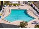 Aerial shot of a sparkling blue swimming pool with ample lounge seating and lush landscaping at 4721 Mount Vernon Dr, Bradenton, FL 34210