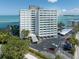 Exterior shot of tall modern building with a circular drive and covered parking at 4822 Ocean Blvd # 2D, Sarasota, FL 34242