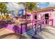 Quaint ice cream shop with vibrant purple exterior, charming landscaping, and inviting entryway at 4822 Ocean Blvd # 2D, Sarasota, FL 34242