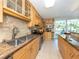 Bright kitchen with granite counters, stainless steel appliances, and lots of natural light at 4822 Ocean Blvd # 2D, Sarasota, FL 34242