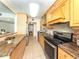 Updated kitchen with wood cabinets, stainless steel appliances, and granite countertops at 4822 Ocean Blvd # 2D, Sarasota, FL 34242
