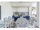 Outdoor kitchen featuring two stainless steel grills, granite countertops, and seating area at 4822 Ocean Blvd # 2D, Sarasota, FL 34242