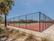 Community tennis court surrounded by tall fences and lush greenery at 4822 Ocean Blvd # 2D, Sarasota, FL 34242