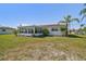 Well-kept lawn and charming exterior of a Florida home, featuring a sunroom and mature landscaping at 4912 Beacon Rd, Palmetto, FL 34221
