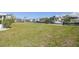 Large grassy waterfront backyard with view of canal and docks at 4912 Beacon Rd, Palmetto, FL 34221