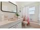 Charming bathroom with a classic pink sink, toilet, and bathtub, accented by coral-themed decor at 4912 Beacon Rd, Palmetto, FL 34221