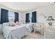 Bright bedroom with two twin beds, blue bedding and white wicker furniture at 4912 Beacon Rd, Palmetto, FL 34221