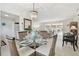 Bright dining area with an elegant chandelier, wicker chairs, and views into the living room and kitchen at 4912 Beacon Rd, Palmetto, FL 34221