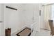 Bright foyer featuring coat rack, white door, neutral rug, and terrazzo flooring, with a glimpse of the dining area at 4912 Beacon Rd, Palmetto, FL 34221