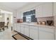 Bright kitchen featuring white cabinets, classic hardware, and a large window with views to the outdoors at 4912 Beacon Rd, Palmetto, FL 34221