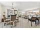 Open-concept living and dining area with terrazzo floors, elegant furnishings, and natural light at 4912 Beacon Rd, Palmetto, FL 34221