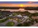 Aerial view of the property showcasing the landscaping, circular driveway, and panoramic view of the waterway at 525 S Shore Dr, Osprey, FL 34229