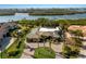 Expansive aerial view of a luxury estate with a waterfront location and manicured grounds at 525 S Shore Dr, Osprey, FL 34229