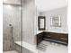 Modern bathroom with a glass-enclosed shower and dark wood cabinets with double sinks at 525 S Shore Dr, Osprey, FL 34229