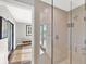 Modern bathroom featuring a glass-enclosed shower with beige tile and a view to the outside at 525 S Shore Dr, Osprey, FL 34229
