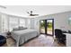 Bright bedroom with a ceiling fan, area rug, and sliding glass doors leading to the backyard at 525 S Shore Dr, Osprey, FL 34229