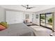 Bright bedroom features a ceiling fan and sliding doors to an outdoor patio area at 525 S Shore Dr, Osprey, FL 34229