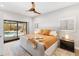 Bright bedroom features a ceiling fan and sliding doors to an outdoor pool area at 525 S Shore Dr, Osprey, FL 34229
