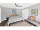 Cozy bedroom featuring a modern ceiling fan, a comfortable seating area, and great natural lighting at 525 S Shore Dr, Osprey, FL 34229
