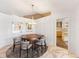 Dining area featuring wainscotting, a round wooden table, unique light fixture, and marble floors at 525 S Shore Dr, Osprey, FL 34229