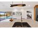Kitchen island with granite countertop and a sink, views of outdoor pool and greenery through sliding glass doors at 525 S Shore Dr, Osprey, FL 34229