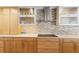 Well-lit kitchen with modern backsplash, countertops, stainless steel appliances, and light wooden cabinets at 525 S Shore Dr, Osprey, FL 34229