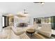 Living area featuring vaulted ceilings, modern fixtures, white walls and couches, and marble floors at 525 S Shore Dr, Osprey, FL 34229