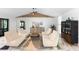 Elegant living room with comfortable seating, unique decor, and a stylish display cabinet at 525 S Shore Dr, Osprey, FL 34229