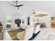 Living area featuring vaulted ceilings, modern fixtures, white walls and couches, and marble floors at 525 S Shore Dr, Osprey, FL 34229