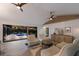 Living area featuring white couches, marble floors, and large sliding doors leading to a pool at 525 S Shore Dr, Osprey, FL 34229