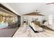 Bright living room with white vaulted ceilings, white couches, and a view of the pool through sliding glass doors at 525 S Shore Dr, Osprey, FL 34229