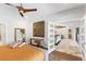 Main bedroom featuring a modern ceiling fan, neutral colors, stylish decor, and an open doorway to a living space at 525 S Shore Dr, Osprey, FL 34229