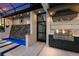 Outdoor kitchen with stainless steel grill, stone accents, and a pass-through window to the indoor space at 525 S Shore Dr, Osprey, FL 34229