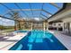 Backyard oasis showcases a pool with a spa and an outdoor kitchen for an entertainer's dream at 525 S Shore Dr, Osprey, FL 34229