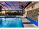Beautiful outdoor screened pool area features a water feature, spa, and lounging space overlooking a sunset view at 525 S Shore Dr, Osprey, FL 34229