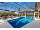 Outdoor living features a screened-in pool area with a spa and outdoor seating at 525 S Shore Dr, Osprey, FL 34229