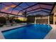 Relaxing screened-in pool with sun loungers and a spa offers a private retreat amidst lush landscaping at 525 S Shore Dr, Osprey, FL 34229