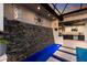 Close-up of a modern water feature with a stone wall and built-in lighting creating a serene ambiance at 525 S Shore Dr, Osprey, FL 34229