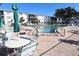 Community pool surrounded by lounge chairs and tables at 5945 17Th W St # A-33, Bradenton, FL 34207