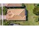 Aerial view of the house with a clay tile roof and a well-manicured lawn at 5946 Caspian Tern Dr, Sarasota, FL 34238