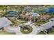 Aerial view of community pool, tennis courts, clubhouse, and lush landscaping at 5946 Caspian Tern Dr, Sarasota, FL 34238