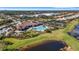 Aerial view of a community pool, tennis courts, and well-maintained landscaping at 5946 Caspian Tern Dr, Sarasota, FL 34238